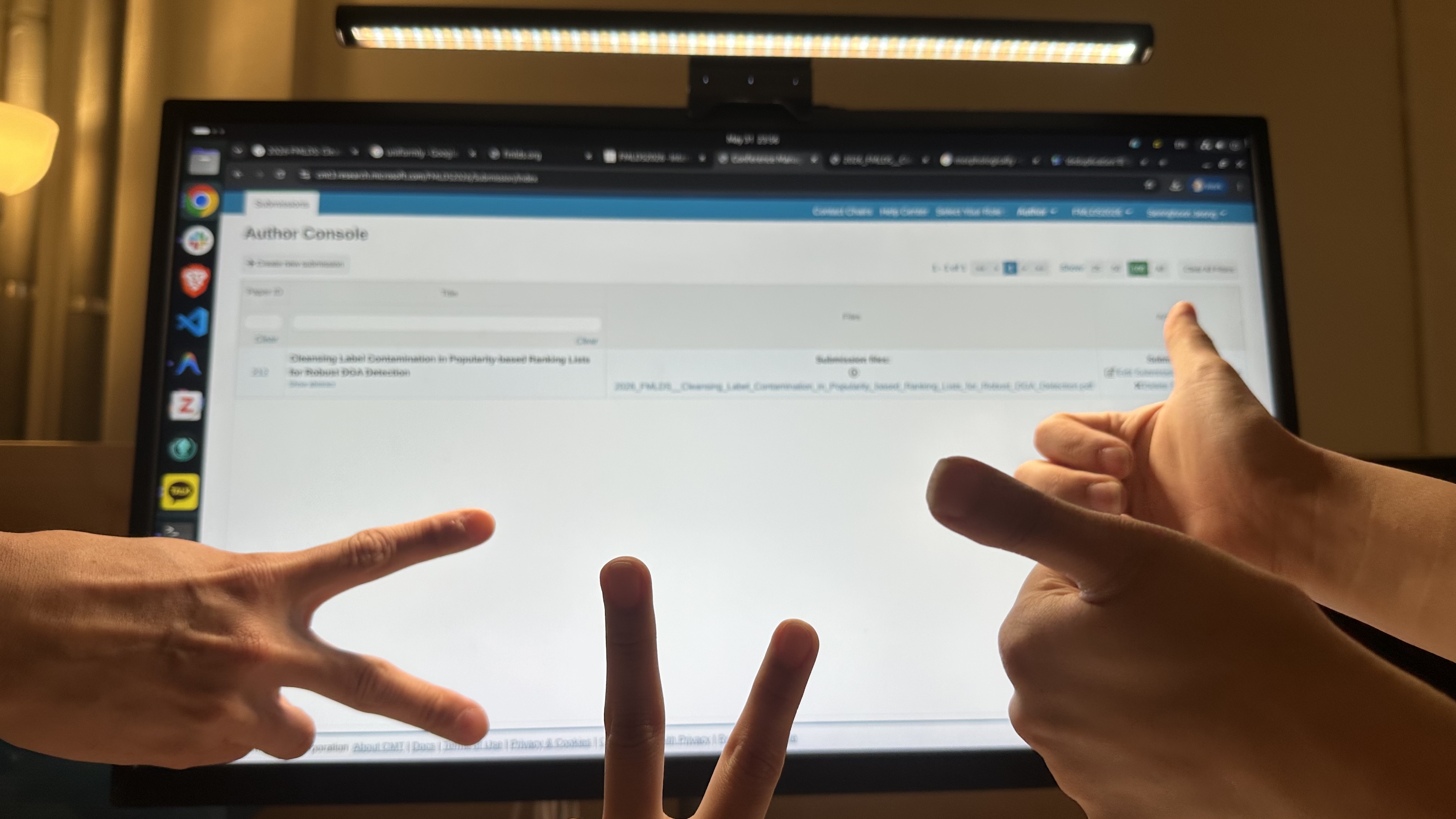 Two of us throwing peace signs at the submission console.
